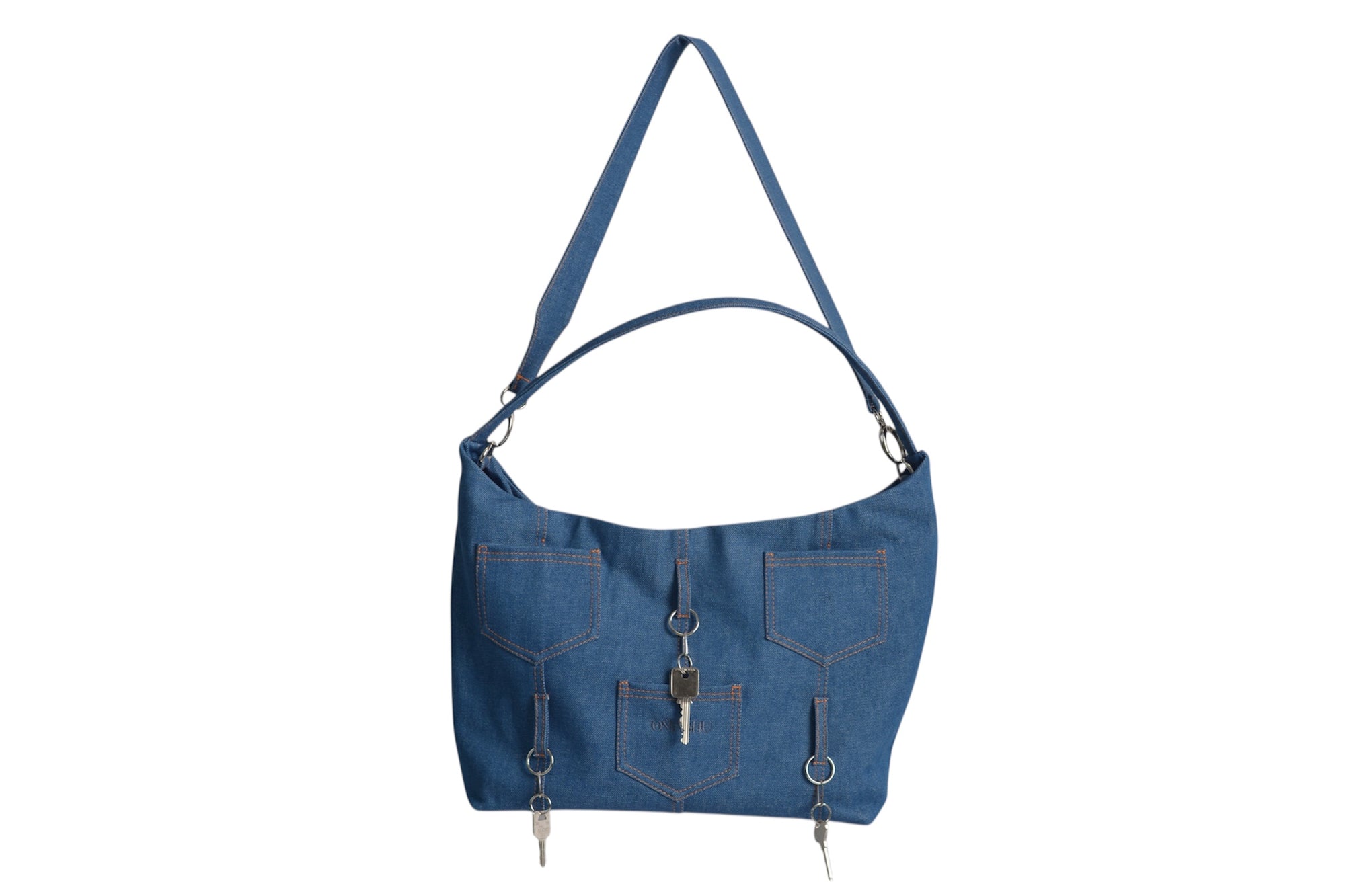 Omashu Ines blue denim shoulder bag with multiple jean-style pockets and decorative key hardware, front 3/4 view.