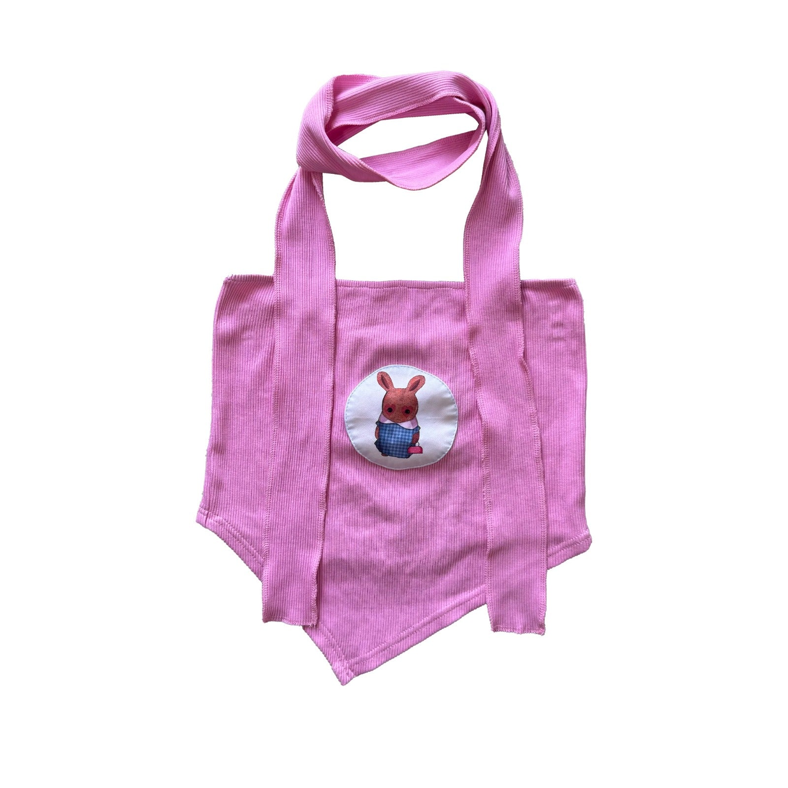 A pink tote bag featuring an embroidered patch of a cartoon-style bunny wearing a blue checkered outfit. The bunny is centered in a circular patch on the front of the bag. The bag has long pink handles, and the overall design is simple, with the bunny illustration as the focal point.