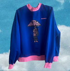 Blue and pink sweatshirt with graphic on front that reads ‘Take Care of Each Other’ in black lettering. Graphic also includes cartoon character with pink hat and skateboard. Small logo on right sleeve that reads ‘OMASHU’. Blue gradient background with cloudy texture.