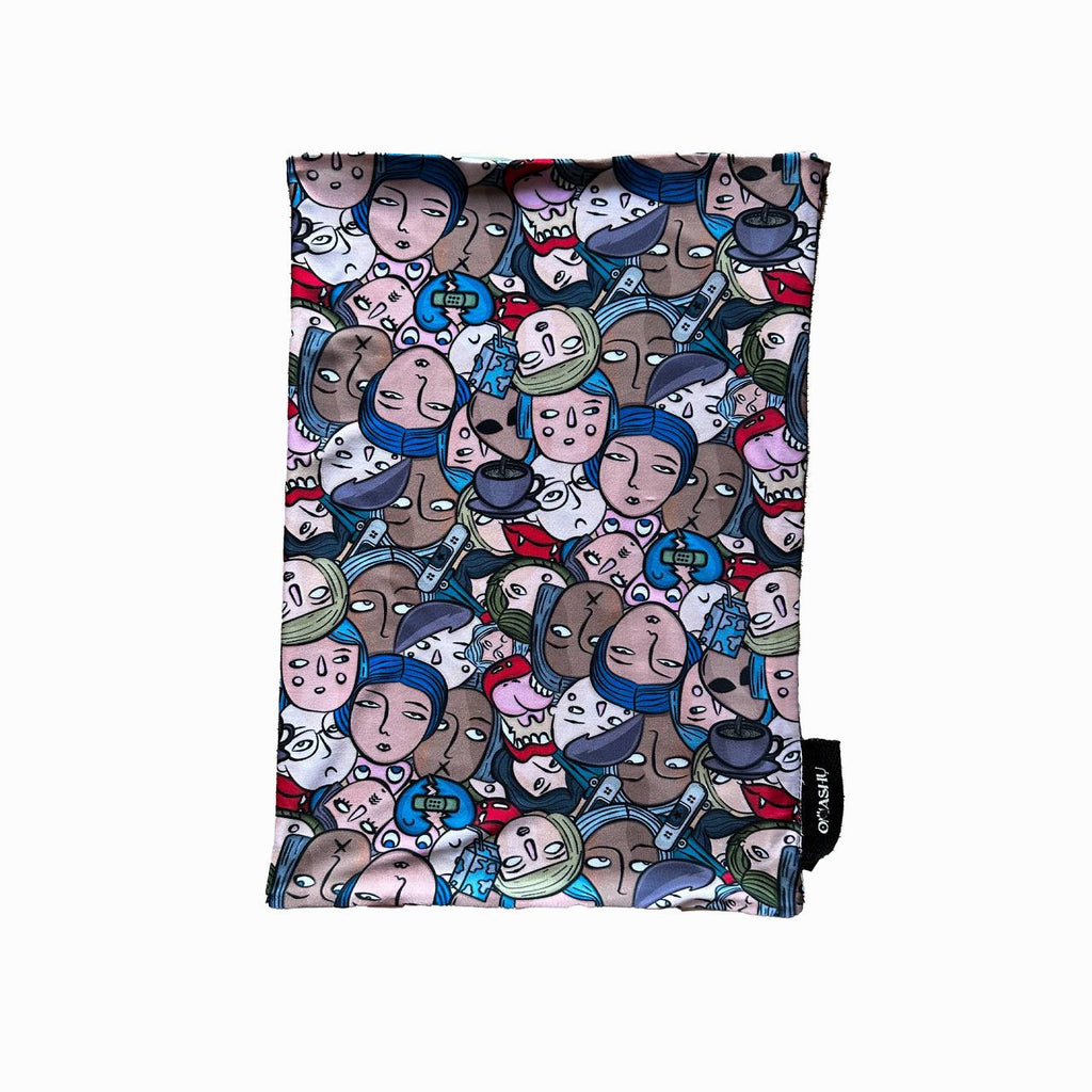 A rectangular piece of fabric with an abstract design featuring overlapping cartoon faces in various colors and expressions. The pattern is filled with busy details, showcasing a mix of emotions and character styles.