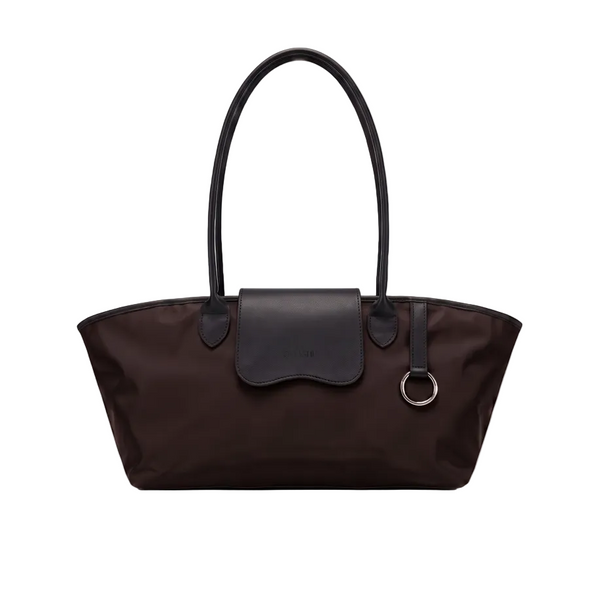 A dark brown nylon tote bag with black leather handles, a matching black leather flap, and a silver-tone metal O-ring detail, shown against a plain light gray background.