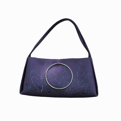 Gray handbag with a circular handle featuring an embossed or stitched flame-like design.