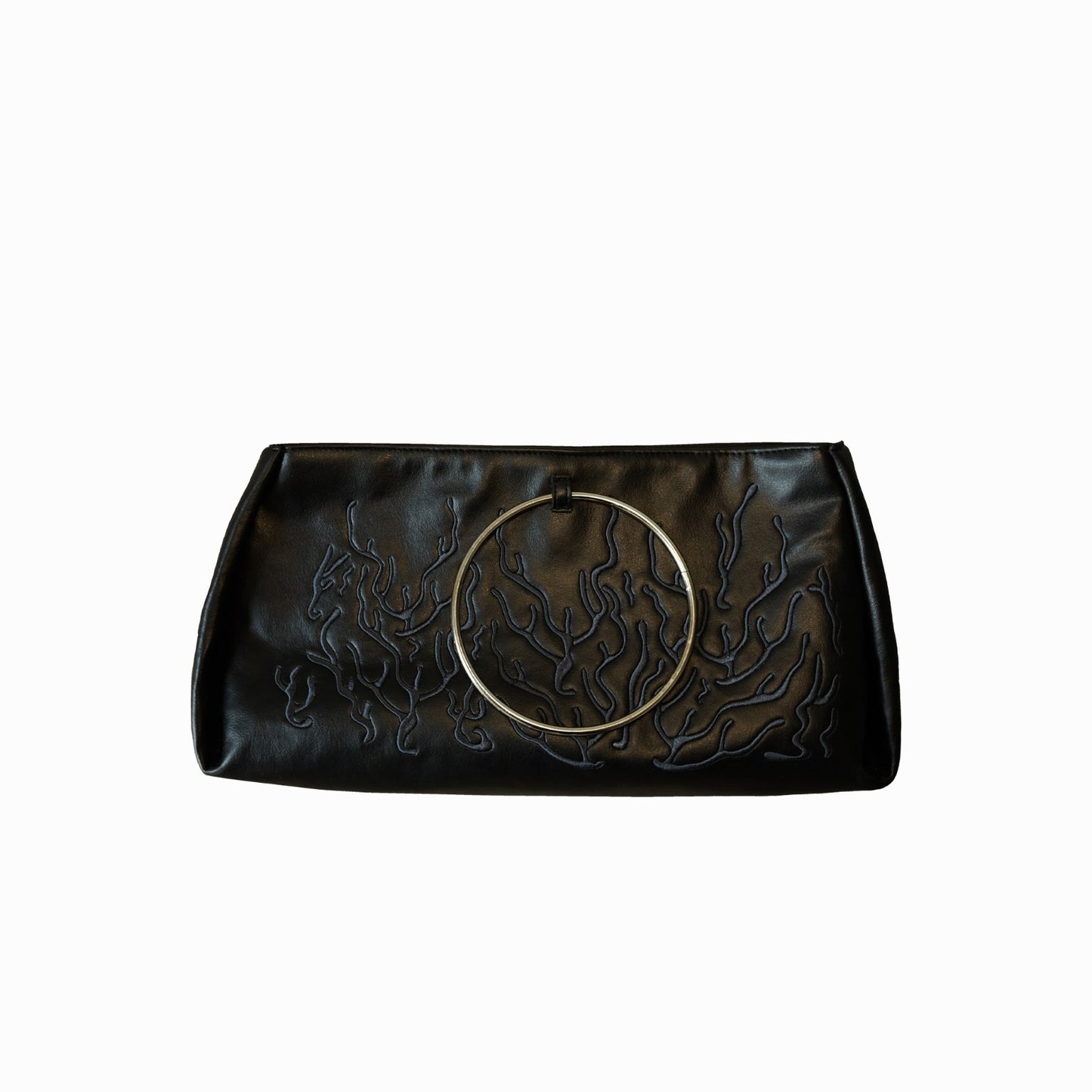 Black bag features a circular and wavy metallic embellishment on the front. Made from faux leather material.