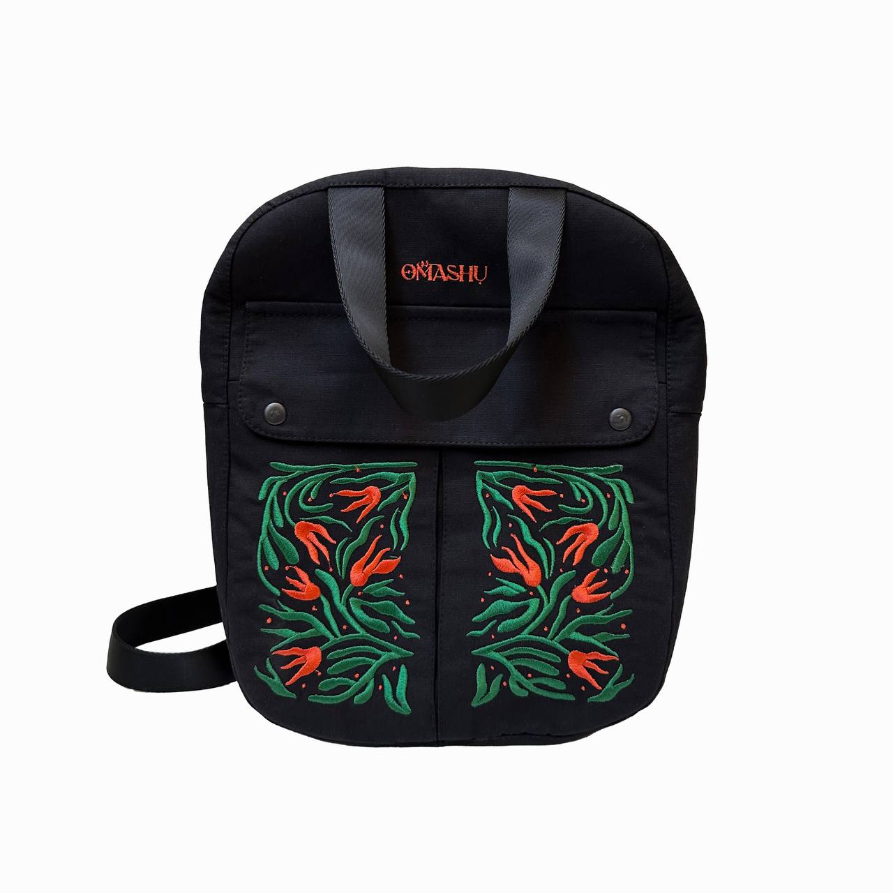 A black OMASHU shoulder bag with a colorful floral design on the front and a red brand name on the handle