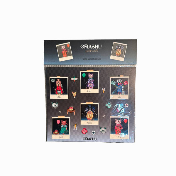 a display board titled "OMASHU Polaroids - dogs and cats edition," featuring several cartoon-style Polaroid images of animals. Each Polaroid frame has a different dog or cat character with names like "Kittie," "Dodo," "Toby," "Mochi," "Jiyah," and "Torin." The characters are adorned with various accessories, including balloons, flowers, and other small whimsical elements like bugs and icons around them. The color scheme is vibrant, and the layout presents each character in a creative, artistic style with in