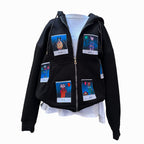 A black zip-up hoodie displayed on a mannequin, featuring six colorful Polaroid-style patches of animal characters. The characters include "Mochi," "Dodo," "Torti," "Jiyah," "Toby," and another on the back. The hoodie is shown with the zipper open, revealing a white inner layer underneath.