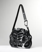 Black leather handbag with unique design on a white background