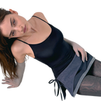 Woman wearing a black tank top and gray skirt on a white background