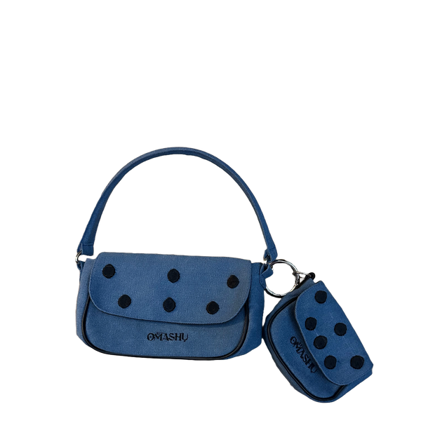 Omashu Nina Loop Dot Bag in blue cotton, showing the main shoulder bag and detachable smaller pouch, both featuring black dot embellishments and OMASHU logo, connected by a silver O-ring.