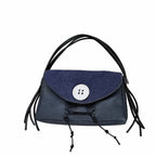 Blue handbag with black straps on a white background
