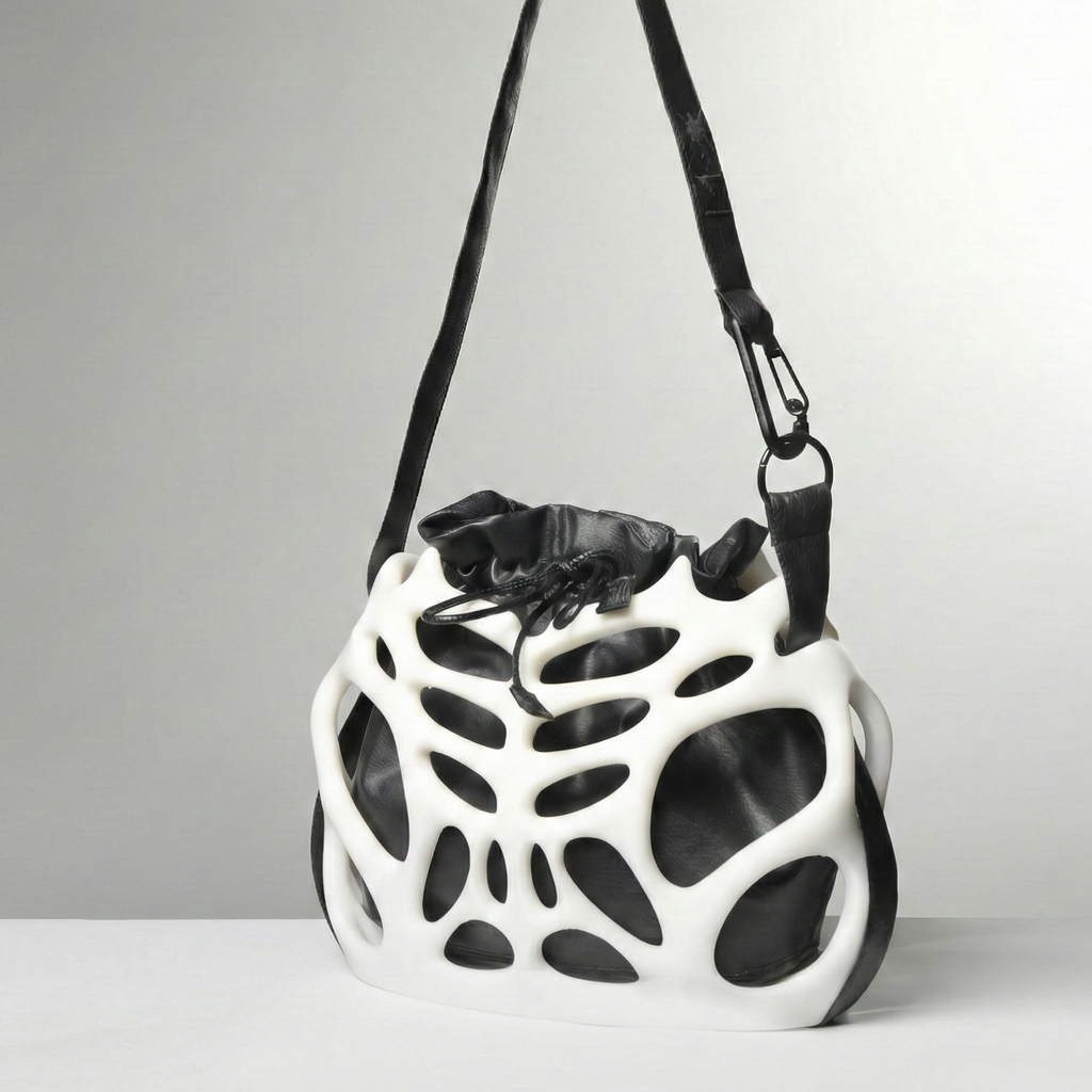 Black and white geometric-patterned bag on a gray background