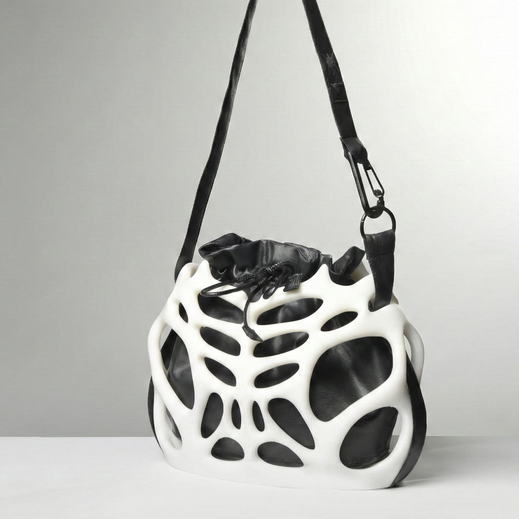 Black and white geometric-patterned bag on a gray background