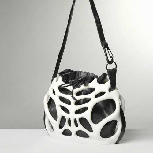 Black and white geometric-patterned bag on a gray background