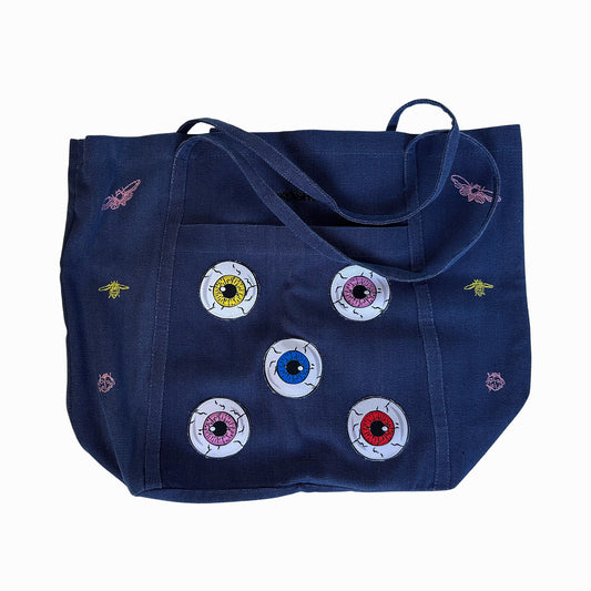 OMASHU clothing brand tote bag with colorful eye designs