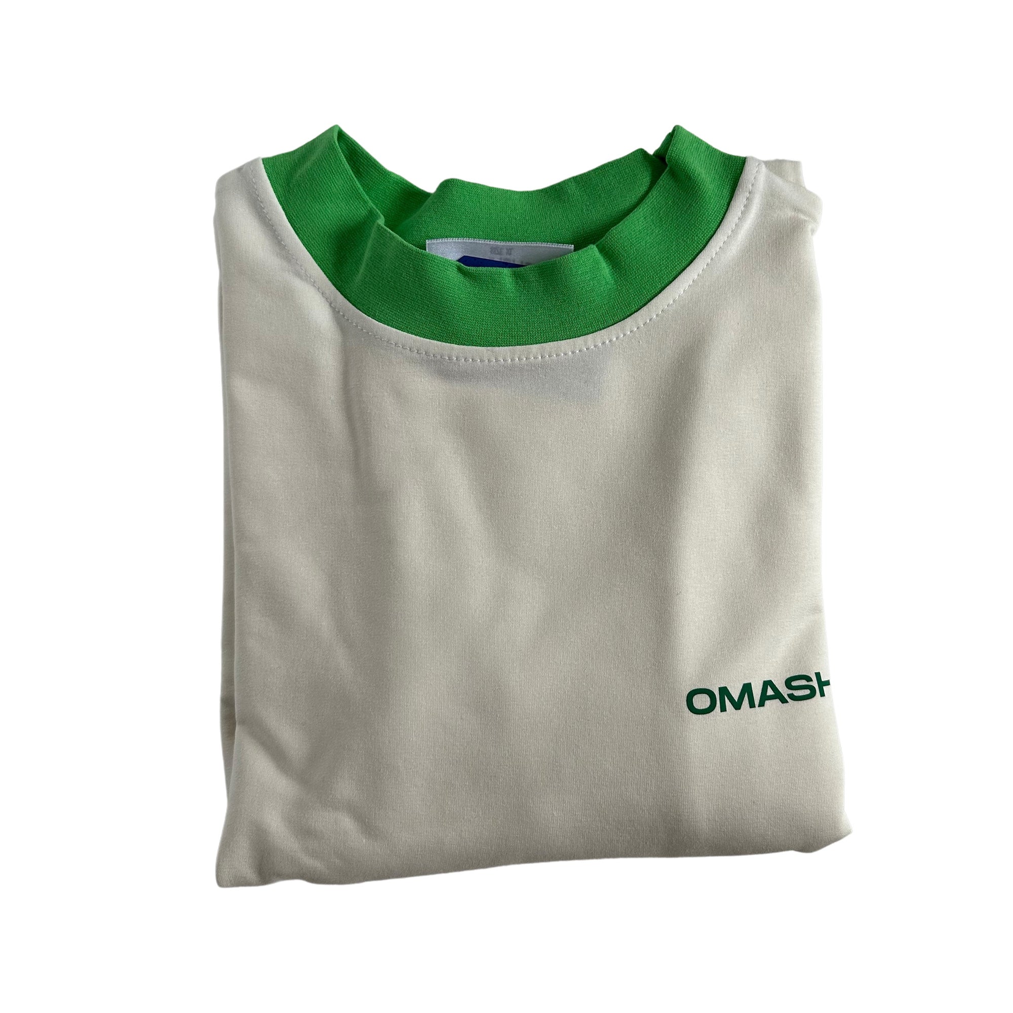 White t-shirt with a green collar and a small green text on the bottom right corner that reads ‘OMASHU’. The t-shirt is neatly folded and has a tag on the inside of the collar.