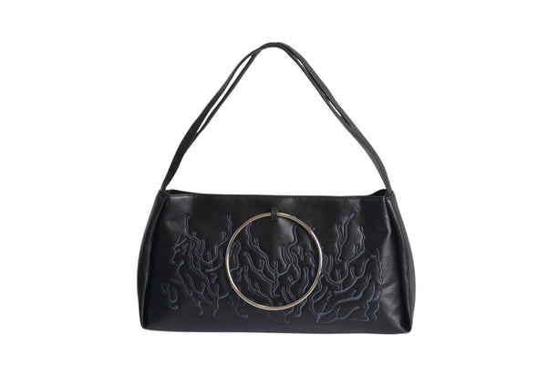 Black bag features a circular and wavy metallic embellishment on the front. Made from faux leather material.