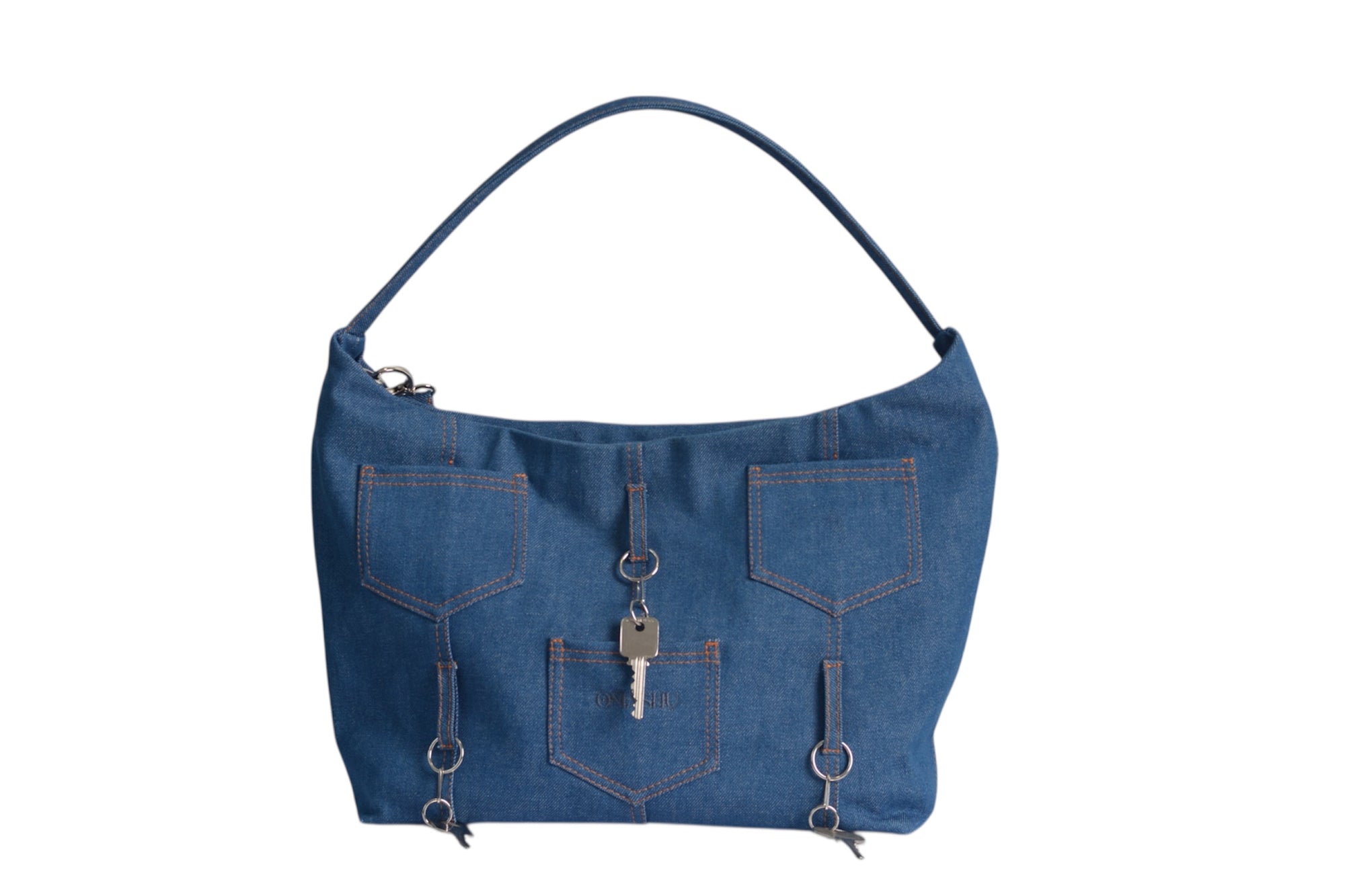 Front view of Omashu Ines denim shoulder bag showcasing three external jean pockets with orange stitching and hanging key details on D-rings.