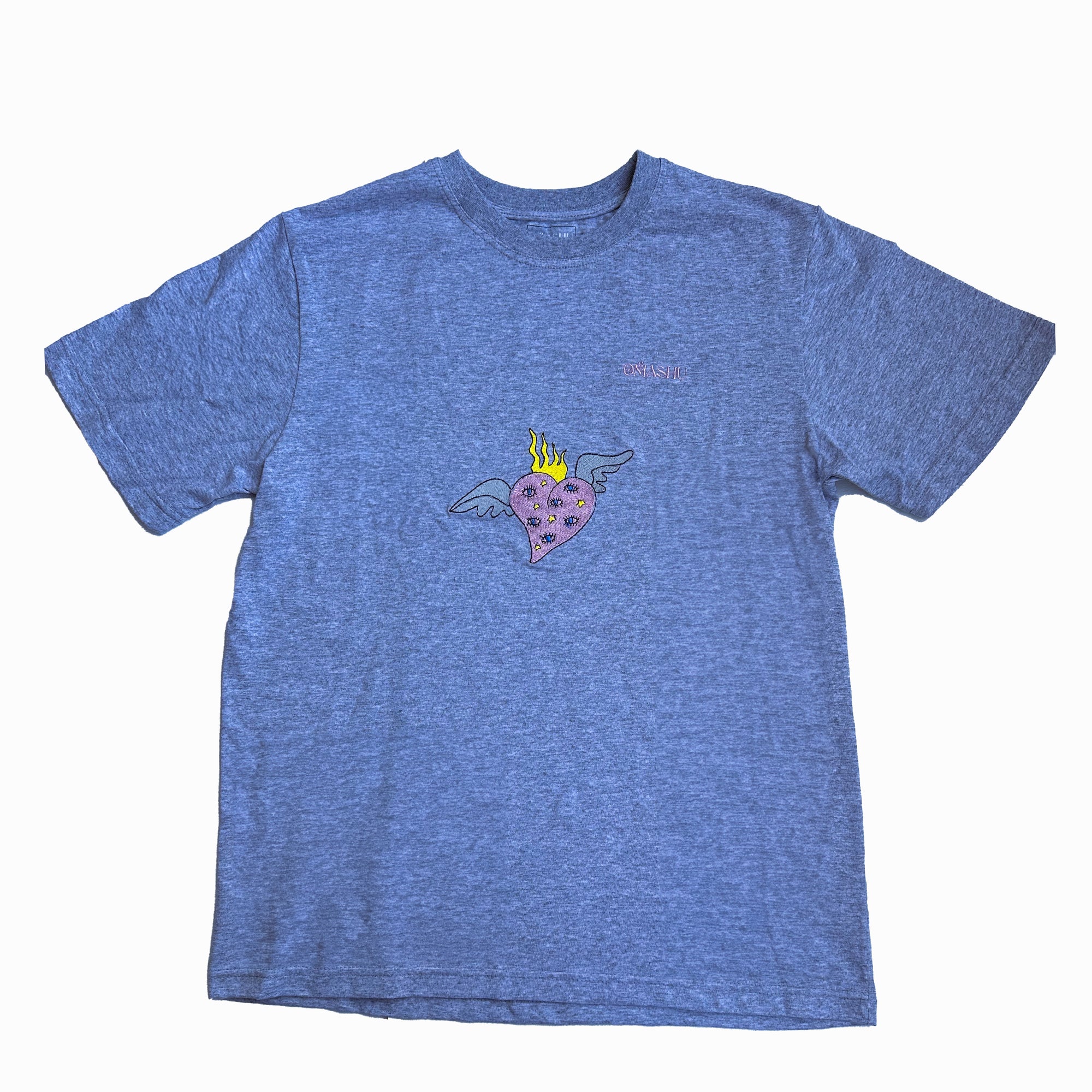 a gray t-shirt with graphic design on the chest area features a heart with wings and flames on its head. The crew neck style with short sleeves. The brand of the t-shirt is “Omashu”, which is written in small white letters on the back of the neck and on chest.