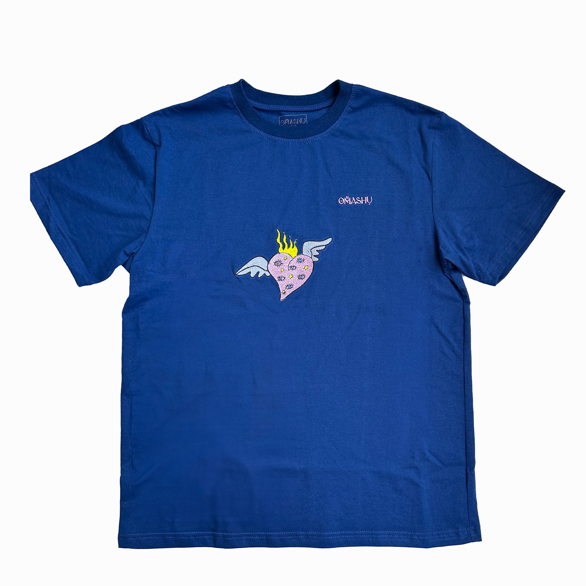 a blue t-shirt with graphic design on the chest area features a heart with wings and flames on its head. The crew neck style with short sleeves. The brand of the t-shirt is “Omashu”, which is written in small white letters on the back of the neck and on chest.