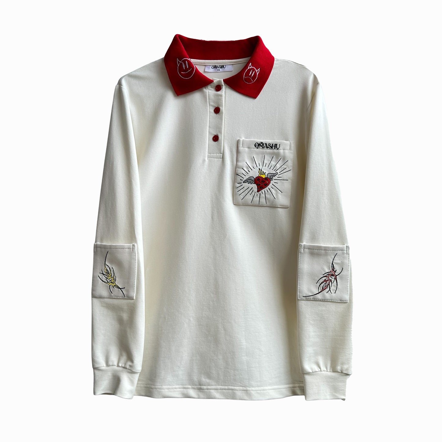 White long sleeve polo shirt with red collar and cuffs. Three buttons on the front and a small pocket on the left chest with a graphic of a red heart with a black outline and the word ‘OMASHU’ above it. Sleeves have two graphics, one of a black bird and the other of a red and black insect.